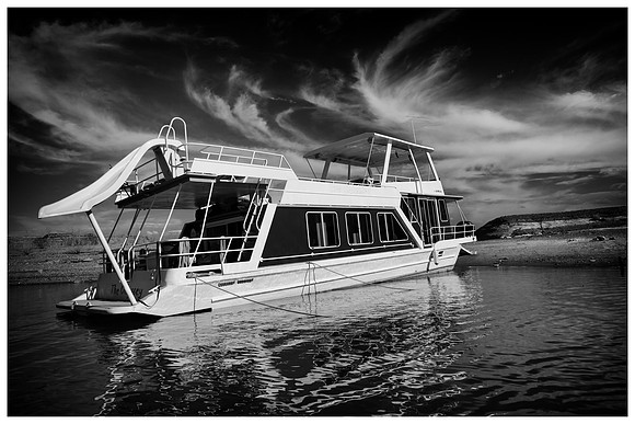 Black and White Lake Powell house boat during summer afternoon light