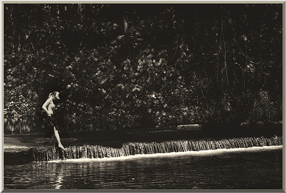 Black and White of woman (Jill) testing the water on Kauai, HI